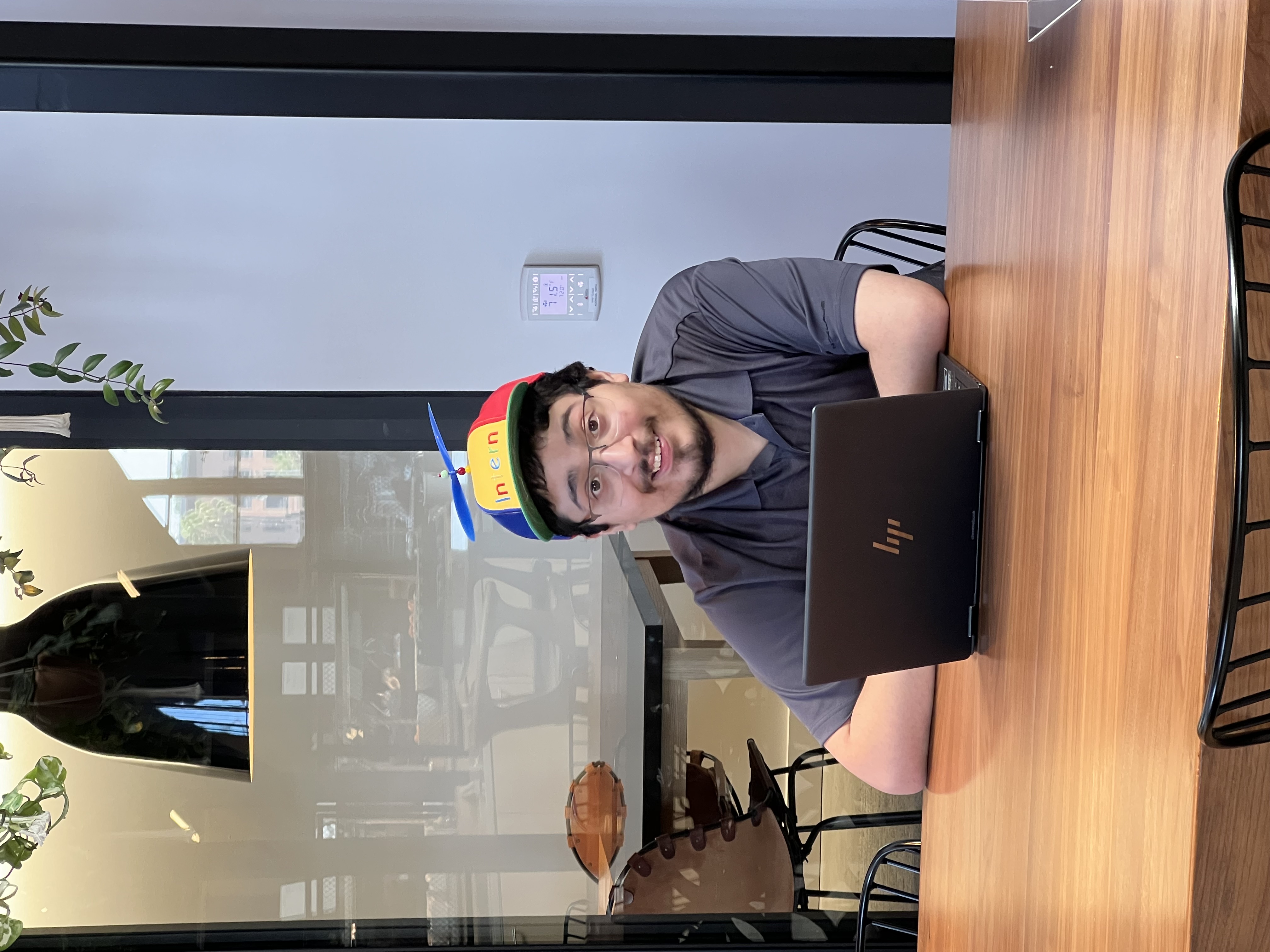 Giovanni inside of the Google Playa Vista office in Los Angeles, CA. in front of a ChromeBook with a propeller hat.